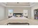 Bright main bedroom features a large bed, soft carpet, recessed lighting, and a walk-in closet at 3173 Rockbridge Rd, Avondale Estates, GA 30002