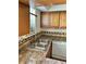 Well-lit kitchen with stainless steel sink, wood cabinets, and a backsplash at 3298 Abbeywood Dr, Decatur, GA 30034