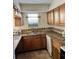 Functional kitchen featuring wood cabinetry, dual stainless steel sink, and efficient layout at 3298 Abbeywood Dr, Decatur, GA 30034