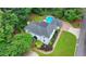 Aerial view of property highlighting beautiful landscaping and a pool in the backyard at 5025 Oak Bluff Ct, Atlanta, GA 30350