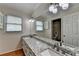 Bathroom boasts granite counters with double sinks, stylish fixtures, and ample cabinet space at 5025 Oak Bluff Ct, Atlanta, GA 30350