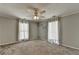 Bright bedroom features natural light from two windows with white curtains and neutral walls at 5025 Oak Bluff Ct, Atlanta, GA 30350