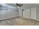 Spacious bedroom with neutral carpeting, ceiling fan, and ample closet space at 5025 Oak Bluff Ct, Atlanta, GA 30350