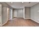 A spacious bedroom with hardwood floors, recessed lights, and a hallway view, providing a clean and versatile space at 5025 Oak Bluff Ct, Atlanta, GA 30350