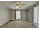 Bright bedroom features natural light from two windows with white curtains and neutral walls at 5025 Oak Bluff Ct, Atlanta, GA 30350