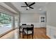 Elegant dining room with wood floors, wainscoting and pool views at 5025 Oak Bluff Ct, Atlanta, GA 30350