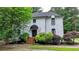 Charming white brick home featuring a covered entryway and beautifully landscaped front yard at 5025 Oak Bluff Ct, Atlanta, GA 30350