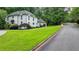Charming white brick home featuring manicured lawn and mature landscaping, offering excellent curb appeal at 5025 Oak Bluff Ct, Atlanta, GA 30350