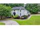 Well-maintained two-story home with lush greenery and a beautifully paved driveway at 5025 Oak Bluff Ct, Atlanta, GA 30350