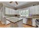 Bright kitchen featuring white cabinets, granite countertops and an island with stainless steel appliances at 5025 Oak Bluff Ct, Atlanta, GA 30350