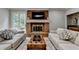 Comfortable living room with brick fireplace and French doors to the backyard at 5025 Oak Bluff Ct, Atlanta, GA 30350