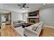 Spacious living room showcasing brick fireplace and adjacent breakfast bar at 5025 Oak Bluff Ct, Atlanta, GA 30350