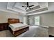 Large primary bedroom with trey ceilings, neutral paint and dual windows at 5025 Oak Bluff Ct, Atlanta, GA 30350
