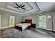 Spacious primary bedroom featuring a trey ceiling and natural light at 5025 Oak Bluff Ct, Atlanta, GA 30350