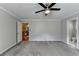 Spacious main bedroom with ceiling fan, neutral walls, and ensuite bathroom access at 5025 Oak Bluff Ct, Atlanta, GA 30350