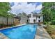 A large swimming pool in the backyard, with an attached garage at 5025 Oak Bluff Ct, Atlanta, GA 30350