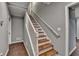 Staircase with wood stairs and white railing, enhances the transition between floors in style and comfort at 5025 Oak Bluff Ct, Atlanta, GA 30350
