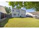 Spacious backyard featuring a well-maintained lawn, mature trees, and rear home elevation at 789 Clairidge Elm Sw Trl, Lawrenceville, GA 30046