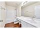 Modern bathroom featuring wood-look floors, a vanity with sink, and a shower-tub combo at 789 Clairidge Elm Sw Trl, Lawrenceville, GA 30046