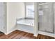 A cozy bathroom features a tub, a shower, and neutral wall paint at 789 Clairidge Elm Sw Trl, Lawrenceville, GA 30046