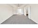 Expansive carpeted bedroom with tray ceiling and double doors leading to closets or bathroom at 789 Clairidge Elm Sw Trl, Lawrenceville, GA 30046