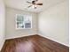 Cozy bedroom with large window, ceiling fan and hardwood floors providing ample natural light at 789 Clairidge Elm Sw Trl, Lawrenceville, GA 30046