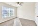Bright bedroom with neutral walls and carpet features a ceiling fan and good light at 789 Clairidge Elm Sw Trl, Lawrenceville, GA 30046