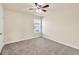 This bedroom has neutral walls, carpet, ceiling fan, and a window with natural light at 789 Clairidge Elm Sw Trl, Lawrenceville, GA 30046