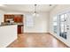 Eat-in kitchen with wood floors, dark cabinets, and access to the backyard at 789 Clairidge Elm Sw Trl, Lawrenceville, GA 30046