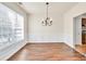 Bright dining room featuring wood floors, wainscoting and large windows at 789 Clairidge Elm Sw Trl, Lawrenceville, GA 30046