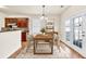 Cozy dining area with hardwood floors and adjacent kitchen offers easy access to outdoor patio at 789 Clairidge Elm Sw Trl, Lawrenceville, GA 30046