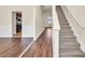Inviting entryway featuring wood floors, staircase, and view to the kitchen at 789 Clairidge Elm Sw Trl, Lawrenceville, GA 30046