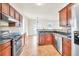 Open kitchen with stainless steel appliances, granite countertops and wood floors, perfect for entertaining at 789 Clairidge Elm Sw Trl, Lawrenceville, GA 30046