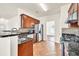 Charming kitchen featuring dark cabinets, granite countertops, and stainless steel appliances at 789 Clairidge Elm Sw Trl, Lawrenceville, GA 30046