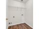 Empty laundry room showcasing laminate flooring and built in shelving above hookups at 789 Clairidge Elm Sw Trl, Lawrenceville, GA 30046