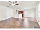 Open-concept living space featuring hardwood floors, a fireplace, and seamless flow to the dining area at 789 Clairidge Elm Sw Trl, Lawrenceville, GA 30046