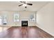 Inviting living room with fireplace, ceiling fan, and hardwood floors, perfect for relaxation at 789 Clairidge Elm Sw Trl, Lawrenceville, GA 30046