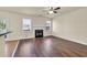 Spacious living room featuring a fireplace, hardwood floors, and access to the backyard at 789 Clairidge Elm Sw Trl, Lawrenceville, GA 30046
