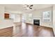 Open living room with fireplace, hardwood floors, and easy access to kitchen and dining area at 789 Clairidge Elm Sw Trl, Lawrenceville, GA 30046