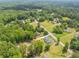 Aerial view of property surrounded by lush green foliage and other homes in the area at 140 Maranatha Trl, Lawrenceville, GA 30045