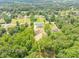 Beautiful aerial perspective of the property featuring a well-manicured lot and serene, wooded surroundings at 140 Maranatha Trl, Lawrenceville, GA 30045
