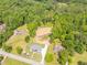 Aerial view showing lot, landscaping, and home with lush greenery in the background at 140 Maranatha Trl, Lawrenceville, GA 30045