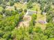 Captivating aerial shot highlighting the property's location amidst mature trees and surrounding neighborhood homes at 140 Maranatha Trl, Lawrenceville, GA 30045