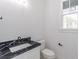 Bathroom features a marble countertop and black hardware at 140 Maranatha Trl, Lawrenceville, GA 30045