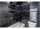 Luxurious bathroom featuring black marble tiles, soaking tub, and modern fixtures at 140 Maranatha Trl, Lawrenceville, GA 30045
