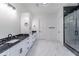 Elegant bathroom features double vanities with marble countertops, modern fixtures, and black-framed glass shower at 140 Maranatha Trl, Lawrenceville, GA 30045