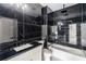 Modern bathroom with black marble tiled walls, soaking tub, and stylish fixtures at 140 Maranatha Trl, Lawrenceville, GA 30045