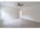 Large bedroom with soft carpet, ceiling fan, modern trim, and doorway to another room at 140 Maranatha Trl, Lawrenceville, GA 30045
