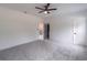 Bedroom with gray carpet, white walls, ceiling fan, and access to an additional room at 140 Maranatha Trl, Lawrenceville, GA 30045