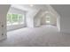 Spacious bonus room with plush carpeting, natural light and neutral paint creates a relaxing and versatile space at 140 Maranatha Trl, Lawrenceville, GA 30045